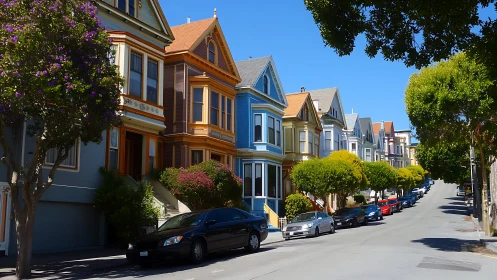 Victorian row houses with colorful facades on sunlit street.