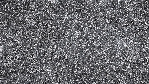 Silver glitter texture covers frame with dense speckled field