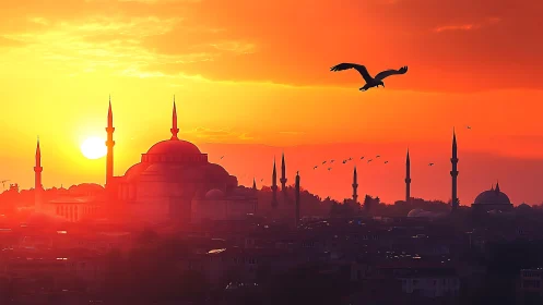 Mosque skyline glows under blazing orange sunset sky.
