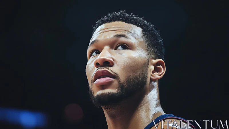 Basketball player looks upward under bright arena lighting