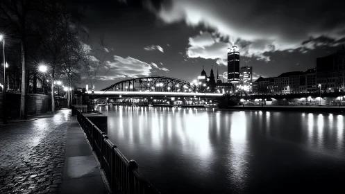 Monochrome long‑exposure riverside skyline with arched bridge.