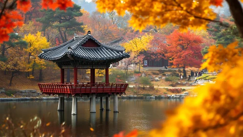 Lakeside Korean pavilion cradled in blazing autumn color veil.