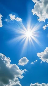 Radiant midday sunburst through cumulus clouds in blue sky.