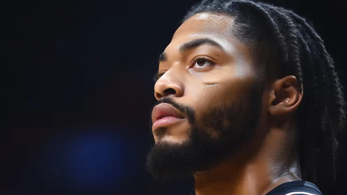 Focused basketball player gazes upward with calm determination