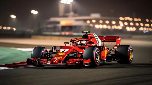 Red Formula 1 car on illuminated night racing circuit.