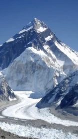 Glaciated Himalayan peak with curving valley glacier under clear sky