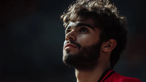 Young man gazes into soft light with hopeful reflection