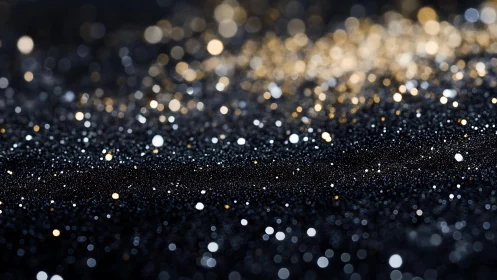 Abstract sparkling black and gold glitter texture background.