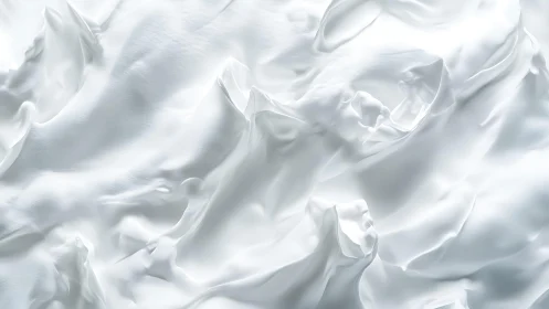 Smooth white silk fabric close-up with soft folds and lighting.