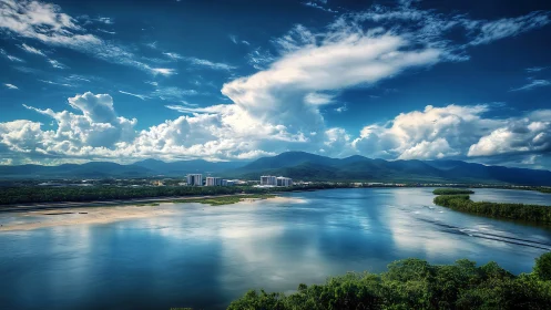 Coastal riverfront city under dramatic cumulus sky panorama.