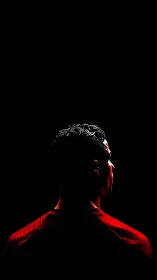 Backlit striker carves a silhouette from molten stadium night