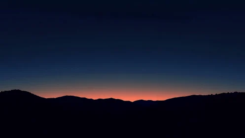 Midnight ridge waits under ember-sliced mountain horizon.