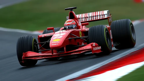 Red Formula 1 car exits high speed corner on racing circuit