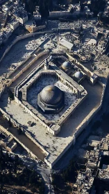 Aerial architectural study of a domed mosque within stone walls