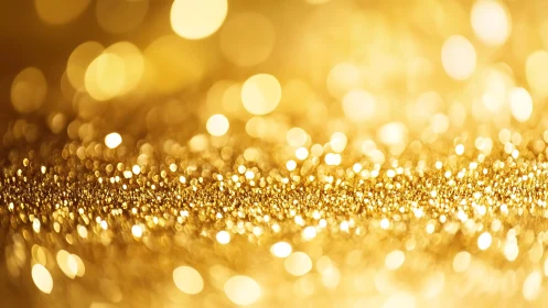 Sparkling gold glitter abstract background with bokeh lights effect.