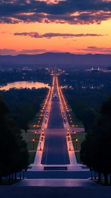 Sunset view down illuminated avenue toward distant city.