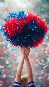 Joyful cheerleader pom-poms held high in colorful confetti.
