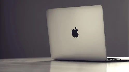 Photorealistic aluminum laptop in minimalist side-back profile.