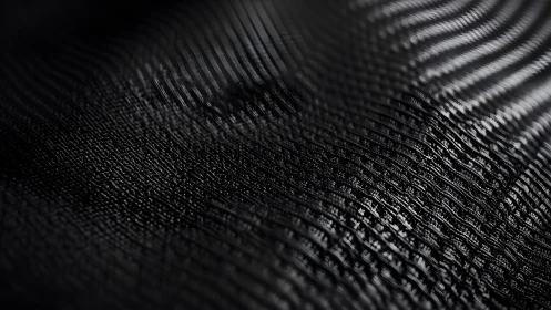 Abstract black wave pattern with textured mesh surface.