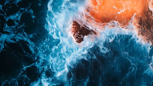 Turbulent surf engulfs rocky outcrop under warm sunset glow