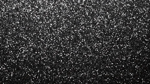 Dense black glitter surface displays uniform granular texture