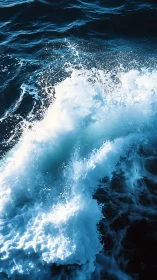 High-contrast ocean wave study with dynamic foam structure.