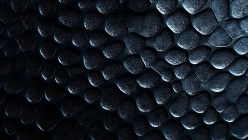 Metallic pebble texture with deep shadowed relief detail.