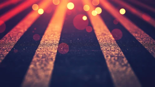 Defocused roadway stripes under warm point light sources.
