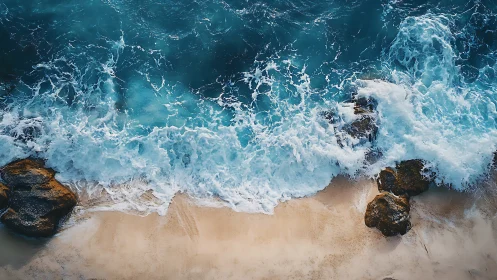 Aerial littoral turbulence over sand and coastal boulders.