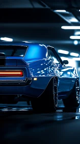 Blue classic muscle car rear view in lit parking garage.