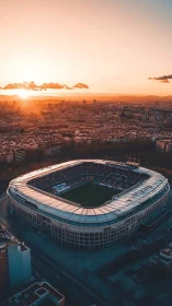 Large football stadium in city at warm sunset light.