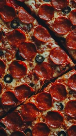 Pepperoni mosaic of sizzling slices and midnight olives.