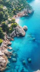 Aerial coastal cove reveals stratified cliffs and cyan shallows