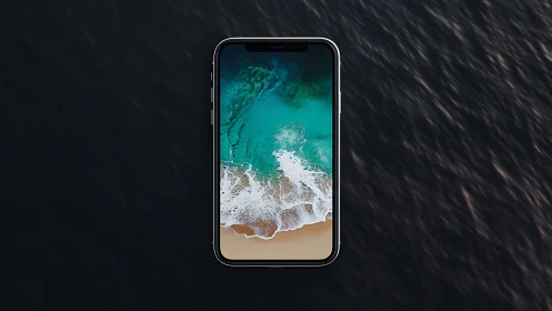 Bezel-less smartphone with ocean wallpaper on dark water surface