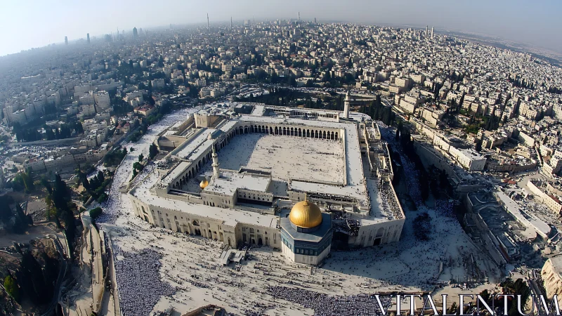 Aerial view of large mosque complex within dense cityscape.