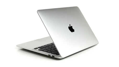 Sleek silver laptop leans open, promising quiet creative speed
