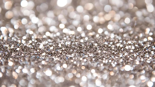 Silver glitter abstract macro background with soft bokeh effect.