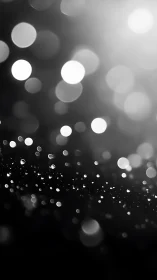 Glowing bokeh orbs in monochrome diagonal drift pattern.