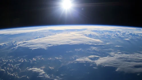 Low Earth orbit perspective shows sunlit cloud deck and limb curvature