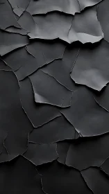 Shattered charcoal sheets composing a quiet lunar crust.