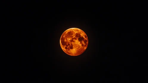 Lunar disc rendered as fiery orange sphere against void