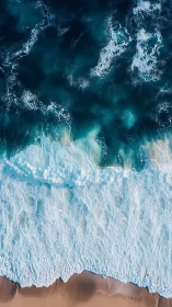 Vertical aerial surf study with layered coastal wave structure.