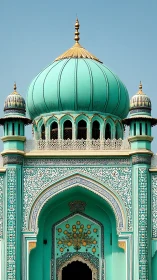 Turquoise mosque dome and ornate arched entrance facade.