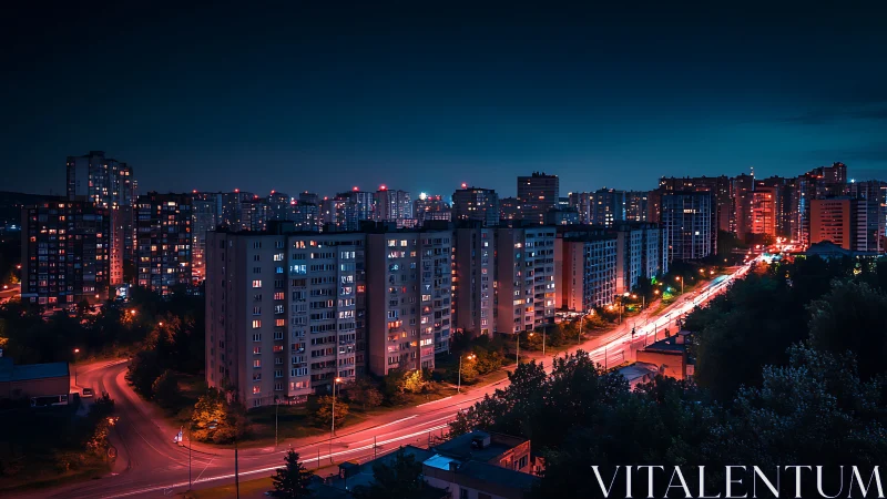 High-rise residential district at night with neon-lit arterial road