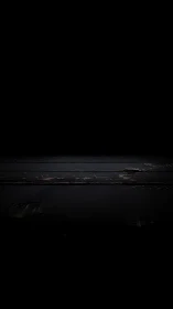 Dark wooden planks receding into negative space with low-key light