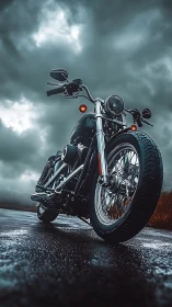 Low-angle motorcycle stands on wet road under storm clouds