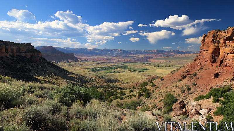 Sunlit red canyon opening toward distant fertile valley plains.