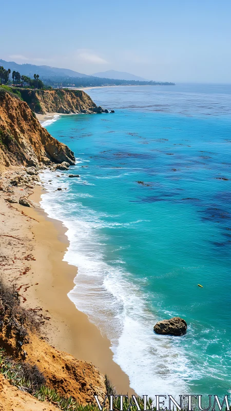 Steep coastal cliffs border turquoise ocean and sandy beach.