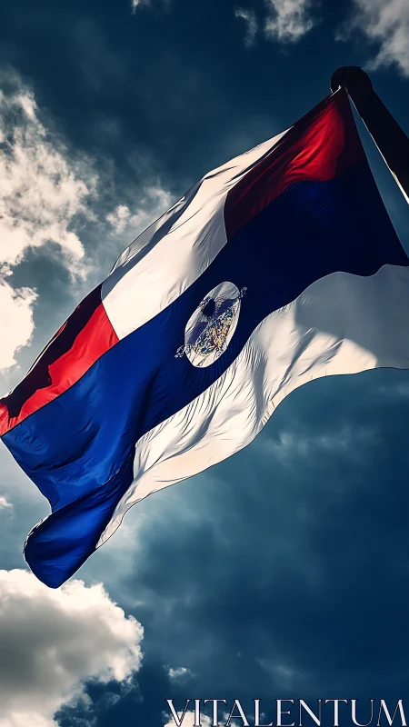 High-contrast national flag under dynamic backlit cloudscape.