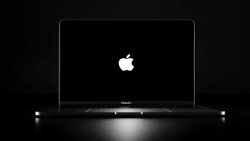 Sleek Apple laptop on dark desk with glowing screen logo.